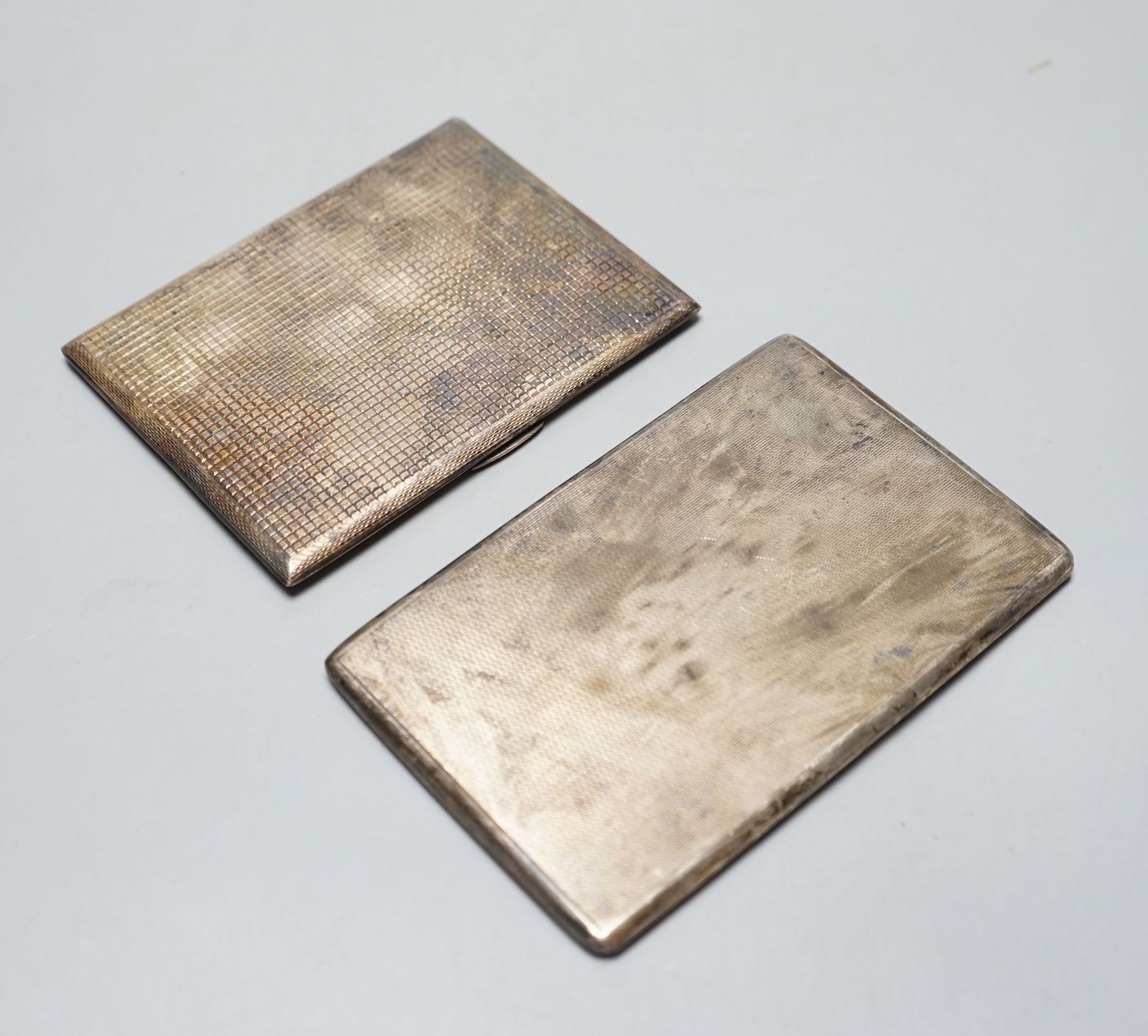 Two 20th century silver cigarette cases, including engine turned, largest, 12.8cm